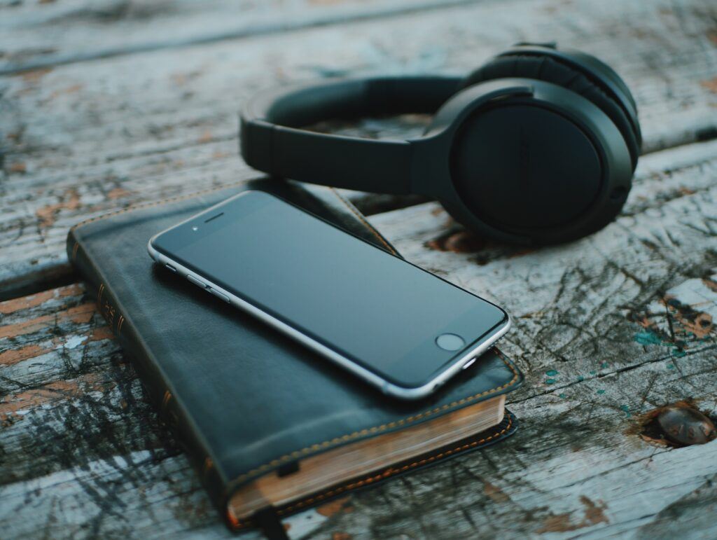 Bible, cell phone, and headphones