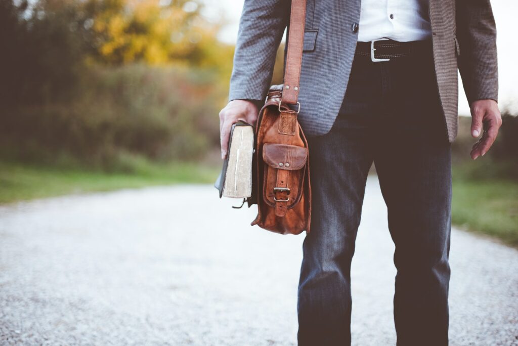 Man with leather bag and Bible