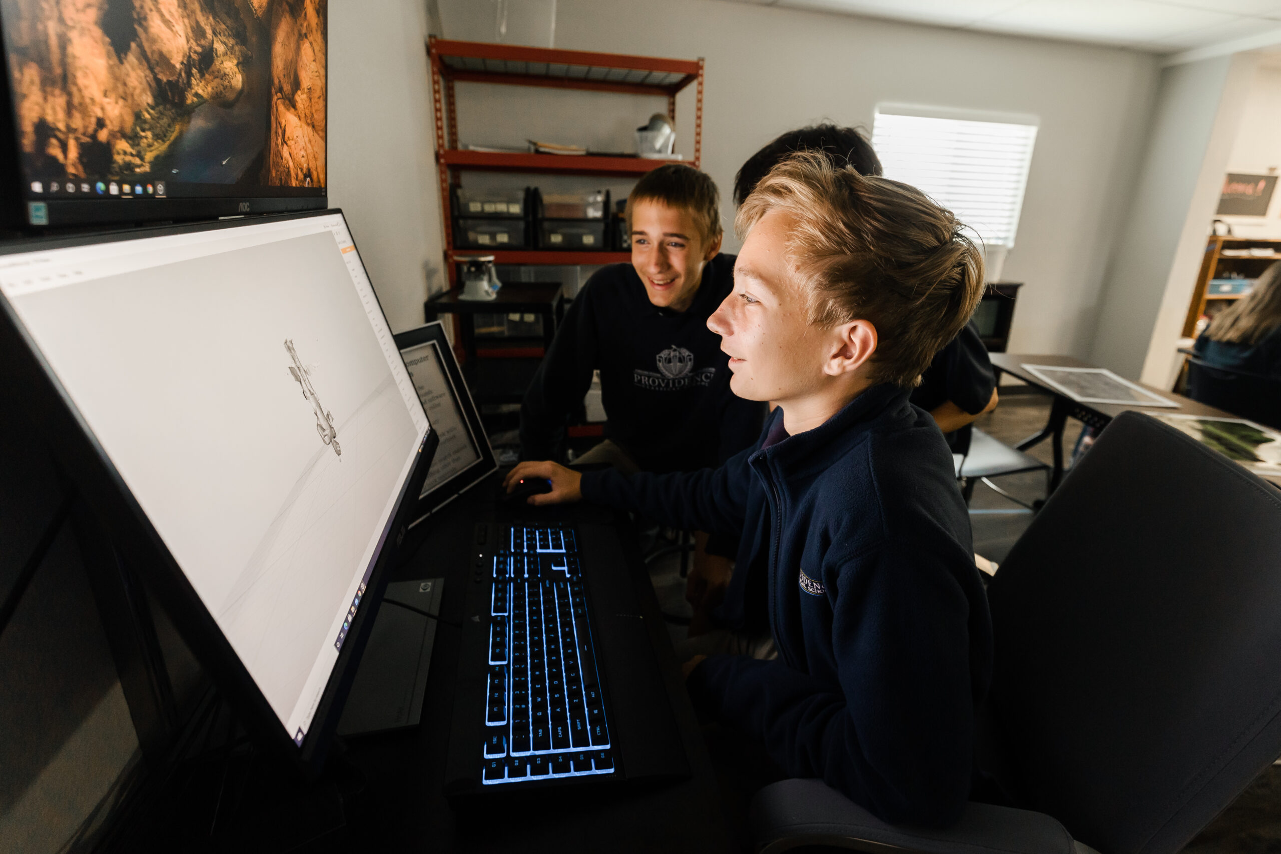 Yearbook students using a computer at Providence Classical School