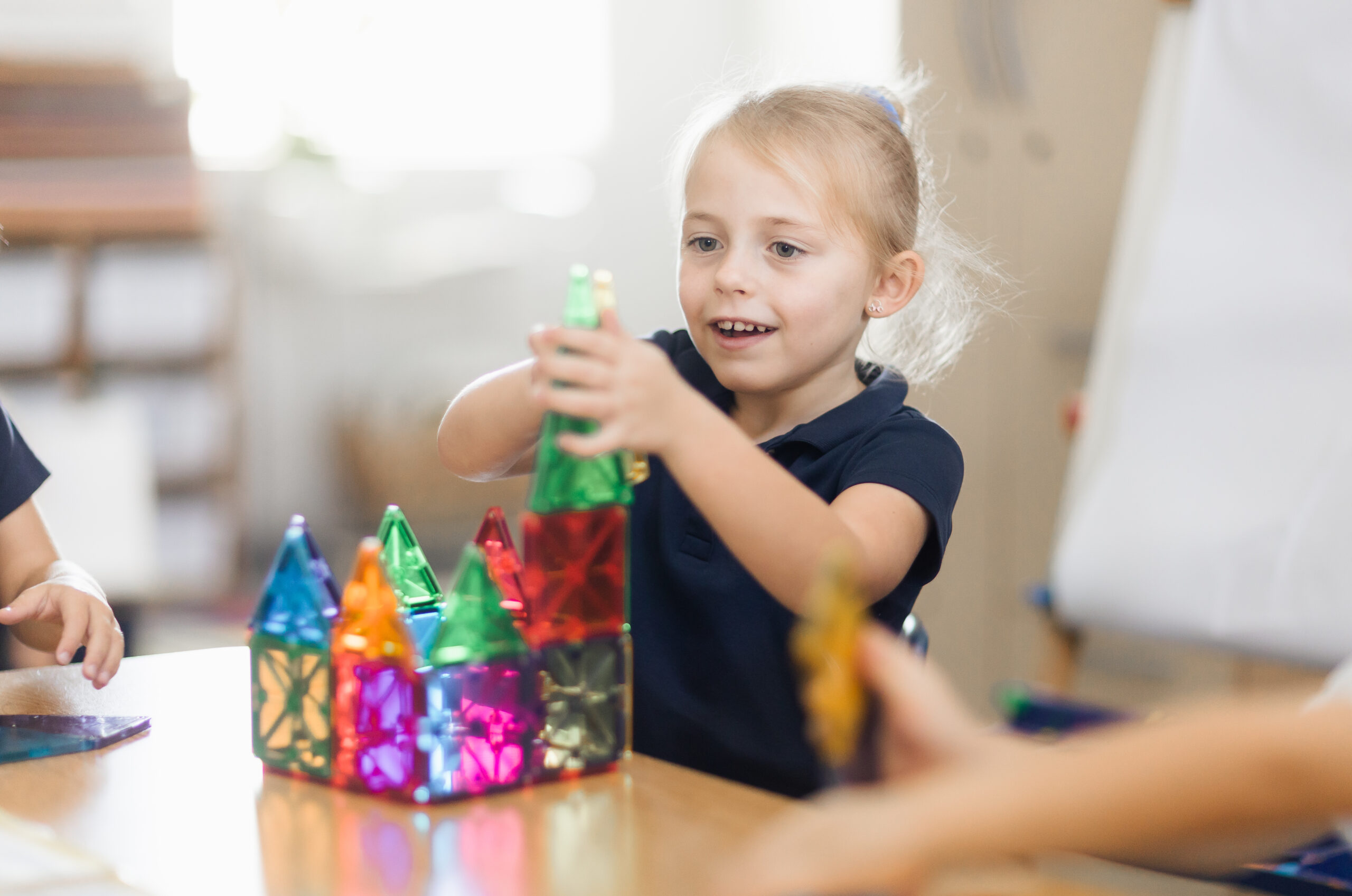 young girl building with shapes